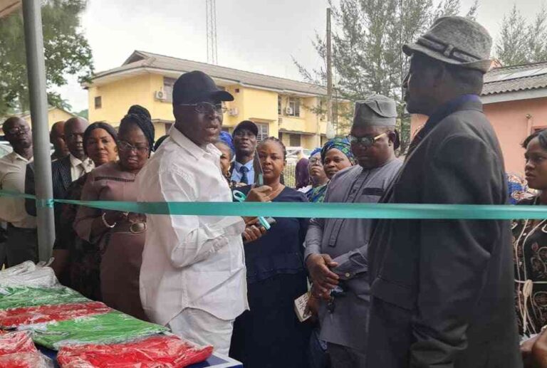 NUT-Chairman-Com.-Raji-cutting-the-tape-while-Mr.-Dairo-looks-on